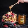 Good Morning Honey liquid honey is drizzled over waffles and fruit