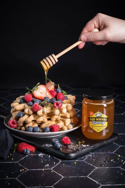 Good Morning Honey liquid honey is drizzled over waffles and fruit
